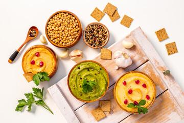 Vegetarian hummus snacks with spinach and chickpeas, flatlay