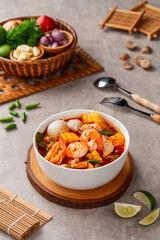 Shrimp soup bowl, Tom yum or tom yam is a type of hot and sour Thai soup, usually cooked with shrimp (prawn). Tom yum has its origin in Thailand.