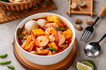 Shrimp soup bowl, Tom yum or tom yam is a type of hot and sour Thai soup, usually cooked with shrimp (prawn). Tom yum has its origin in Thailand.