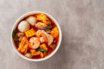 Shrimp soup bowl, Tom yum or tom yam is a type of hot and sour Thai soup, usually cooked with shrimp (prawn). Tom yum has its origin in Thailand.