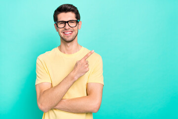 Photo of funny brunet young guy index promo wear eyewear yellow t-shirt isolated on turquoise color...
