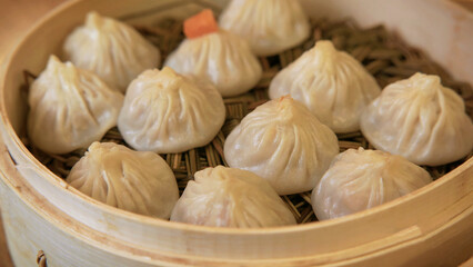 Dim sum on wooden tray. Asian traditional damplings. Shanghai steemed street food.