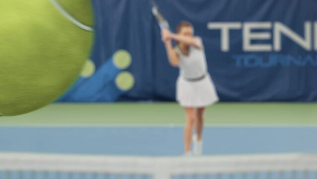 Sports TV Female Tennis Match on Championship with 3D Special Effect Ball. Female Tennis Player Serving Ball with a racquet, Ball Flying into Screen. Live Network Channel Television. VFX Animation