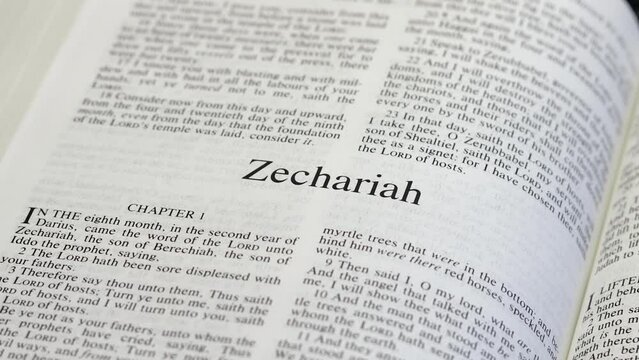 Close Up Shot of  Bible Page Turning to the book of Zechariah
