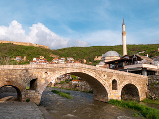Old Ottoman bridge and mosque in Prizren, Kosovo just before sunset