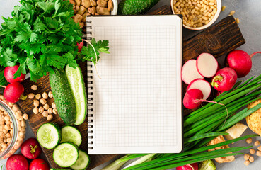 Diet plan concept. Healthy food ingredients. Blank notebook with fresh vegetables, herbs, legumes...