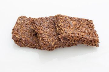 three brown flax seeds on white plate