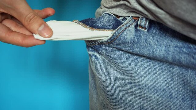 Empty pockets. Man looking for money in an empty pocket