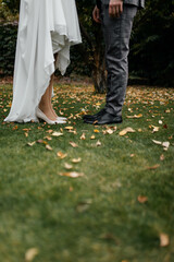 bride and groom walking in park