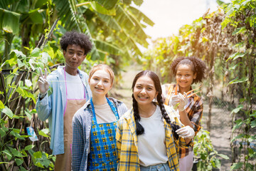 Portrait of teenage girl and boy playing in the vegetable garden.