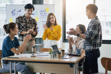 Young businessman team meeting clapping motivating colleagues.