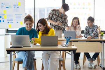 Young people working together in the office. Collaborating with colleagues, discussing, discussing, planning together in the office.