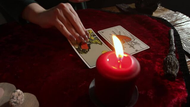 The tarot card reader lays out the cards with pictures up.