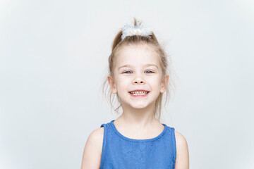 Naklejka premium portrait of a cute 5 year old girl on a light background
