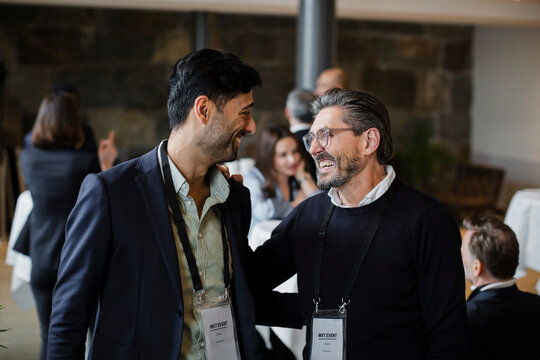 Happy business delegates looking at each other in seminar
