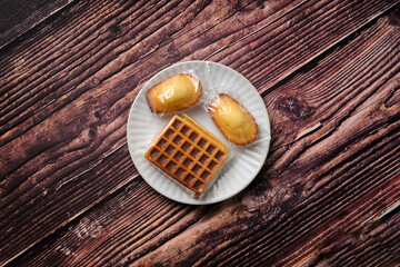 Showing the problem with disposable plastic, waffles &  Madeleine cakes. These sweet tweets come with a sizable side of plastic.