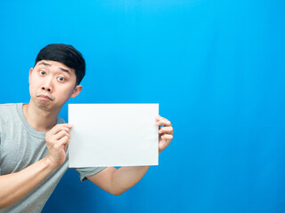 Man show empty white sheet in hand blue background