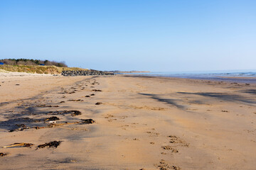 A cloudless spring morning on East Chevington Bay beach on the Northumbrian coast.