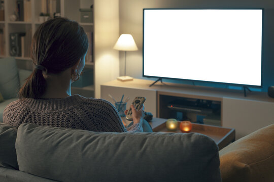 Woman watching TV and relaxing at home