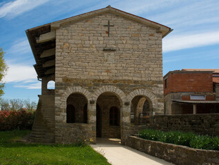 Fototapeta na wymiar A church building in the grounds of St Mark’s Church in the village of Kascerga in Istria, Croatia 