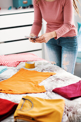 Woman taking pictures of her clothes