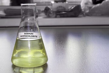 Sodium hypochlorite in glass flask. Formula NaClO. The concept of a chemical reagent for a product card on a website. High quality photo - obrazy, fototapety, plakaty