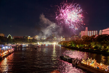 Purple fireworks explode over riverside at summer festival