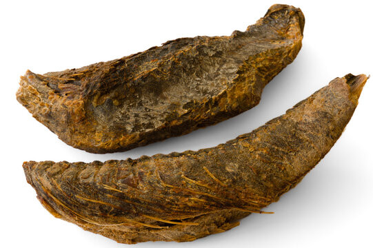 Two chunks of umbalakada aka dry maldive fish on white background