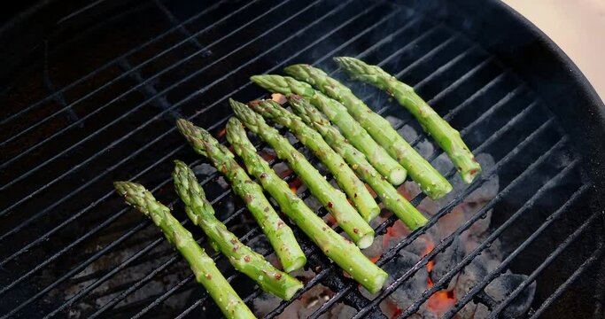 Zooming in on asparagus grilling on BBQ