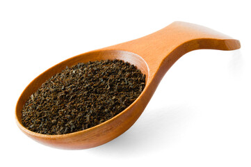 Isolated wooden spoon with Ceylon BOP broken orange pekoe tea on white background
