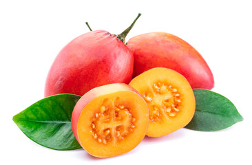 Ripe tamarillo fruits with slices and tamarillo leaves isolated on a white background.