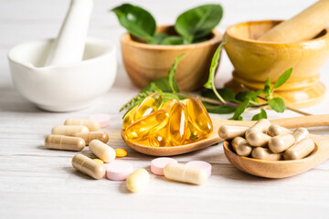 Obraz na płótnie Canvas Alternative medicine herbal organic capsule drug with herbs leaf natural supplements for healthy good life.