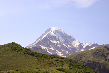 Fototapeta premium Peak Of Mount Kazbek Covered With Snow. Stepantsminda, Gergeti, Georgia.