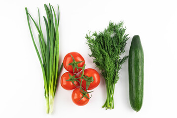 Green onions, tomatoes, cucumber and greens on a white background. Recipe.