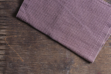  Kitchen towels on brown background top view closeup