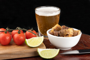 Portion of pancetta served with beer.