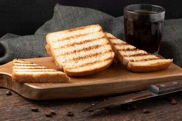 Toasted bread with black coffee. Selective focus.