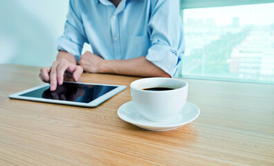 Man using digital tablet in coffee shop