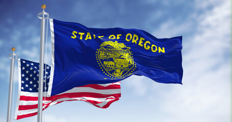 The Oregon state flag waving along with the national flag of the United States of America - obrazy, fototapety, plakaty