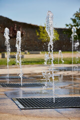 Water game. Fountain with several vertical water jets