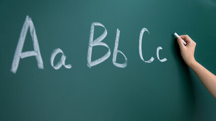 Alphabet abc hand chalk on blackboard