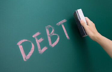 Hand erasing word debt on background
