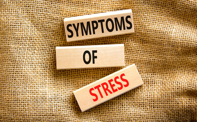 Symptoms of stress symbol. Concept words Symptoms of stress on wooden blocks. Beautiful canvas table canvas background. Psychological business and Symptoms of stress concept. Copy space.