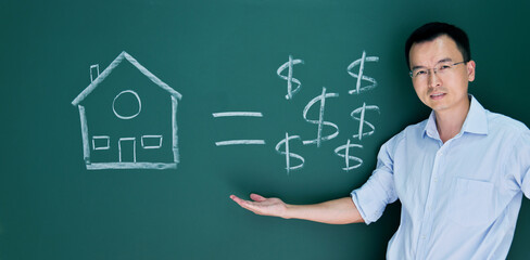 Man in front of drawing house and money on blackboard