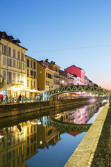 Milan Navigli Milano restaurant and bar district travel traveling holidays vacation town blue hour portrait format in Italy