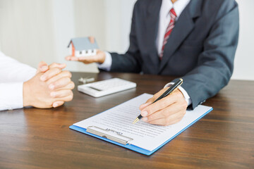 Real estate brokers or real estate agent customer Discussions about contracts , real estate agent holding house in hand, The deal was successful.. Business property Concept.