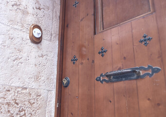 old ceramic doorbell on the wall of a door of a Castilian house