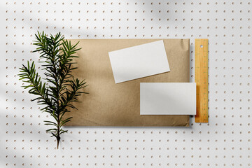 Clean minimal business card mockup on envelope with leaves