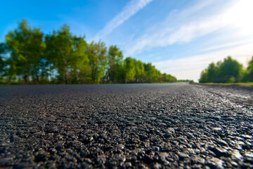black asphalt road closeup tarmac view scenery with blurred background. Selective focus.
