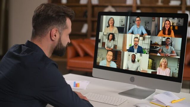 Bearded man in formal wear using app for distance video communication with coworkers, webinar participants, meeting online in pandemic, looking at the laptop screen with people profiles